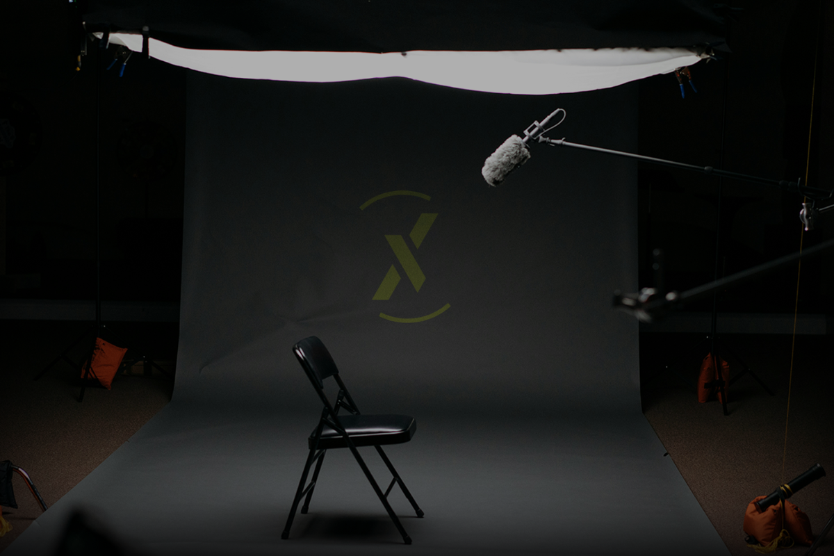 Professional studio setup featuring a chair, microphone, and the XONDER logo backdrop.