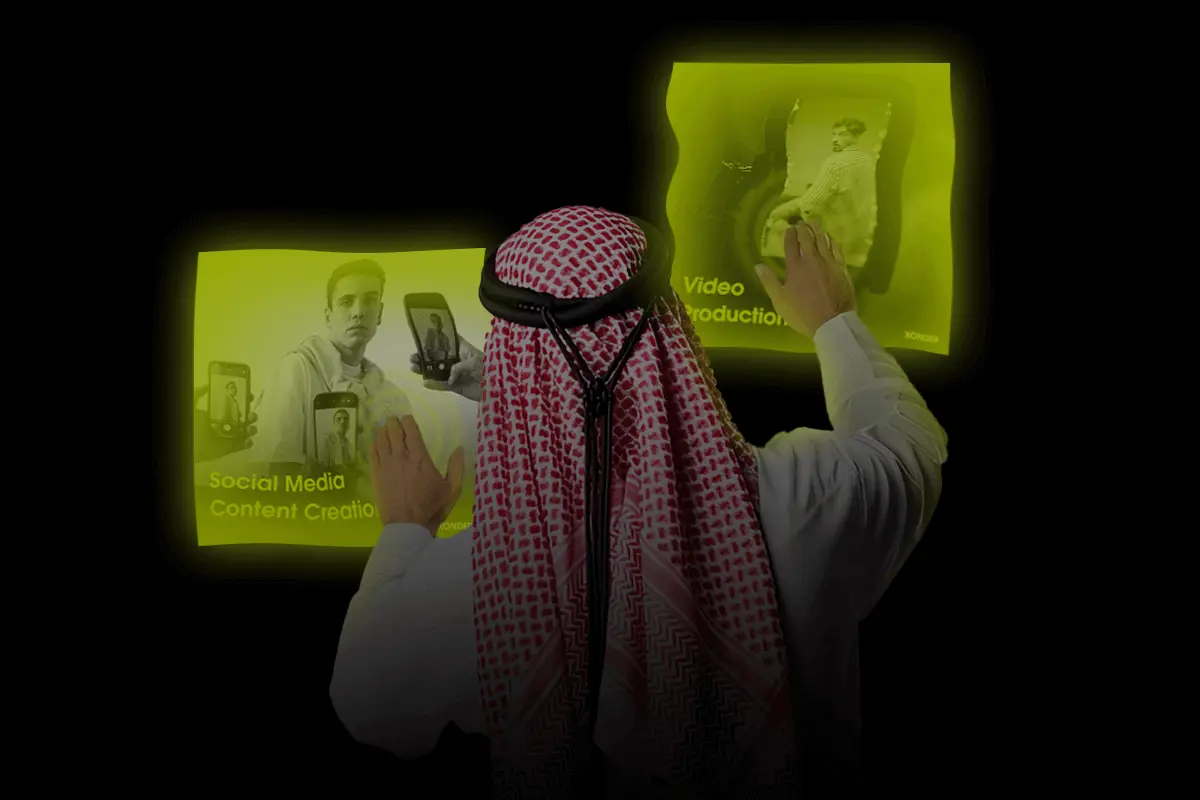 Interactive display with Saudi man selecting video production and social media content creation services.